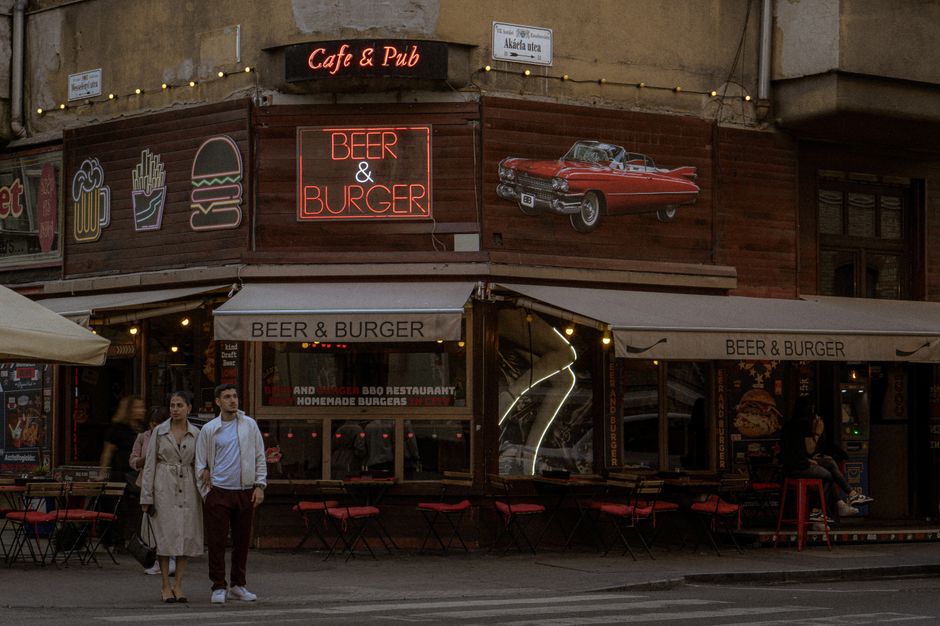 Kapana district Plovdiv Bulgaria outdoor cafe neon lights people drinking