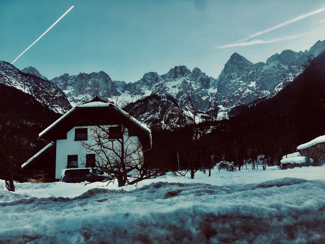 Kranjska Gora Slovenia mountain hut exterior snowy peak background