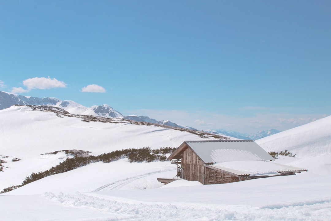 Korab Mountain refuge hut wooden structure snowy roof alpine surroundings