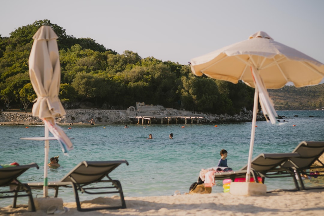 Ksamil Beach Albania sunbeds turquoise water early morning