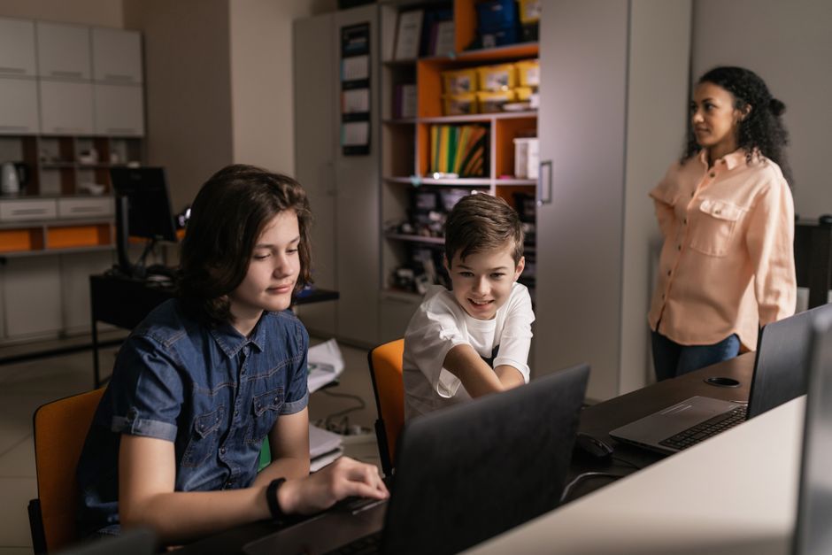 Serbian students using laptops in modern classroom