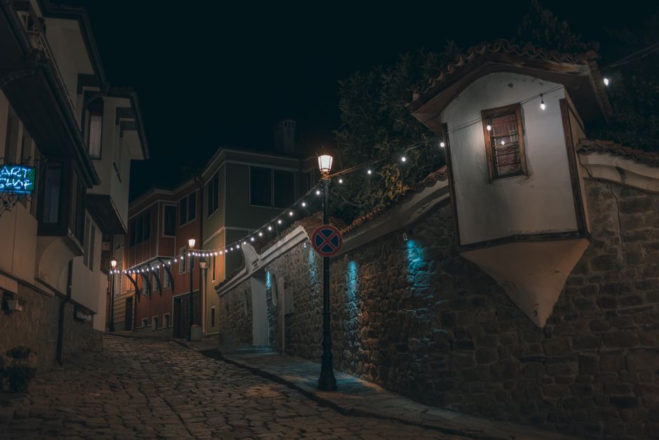 Borovets main street Bulgaria evening bar outdoor seating mountain backdrop