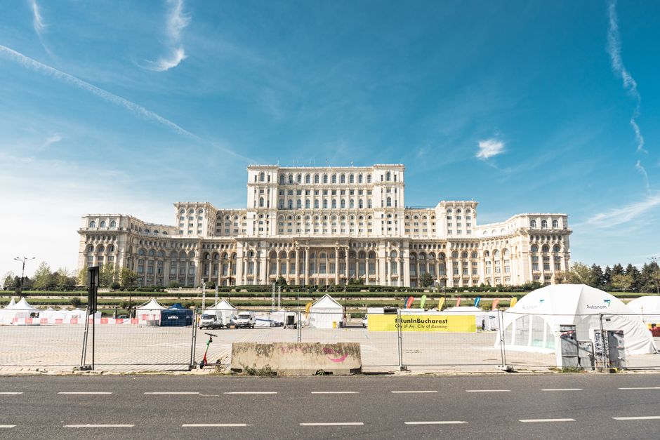 Romanian flag waving in front of government building