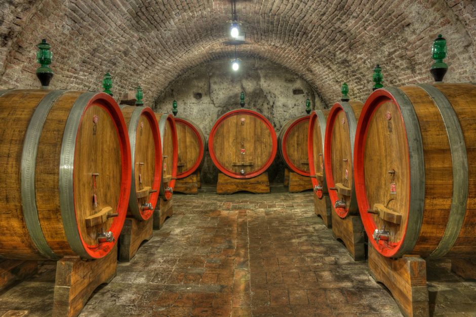 Ciumeghiu wine cellar Romania stone arches barrels fog
