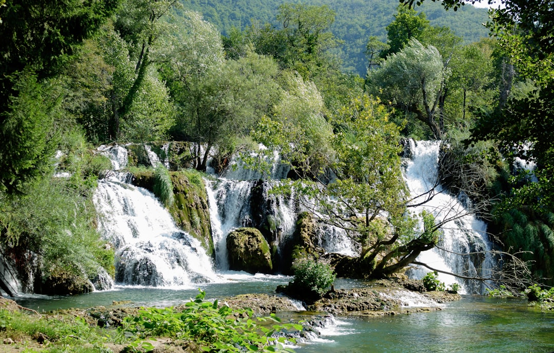 Strbac Buk Waterfalls Bosnia kayaker navigating turquoise cascade