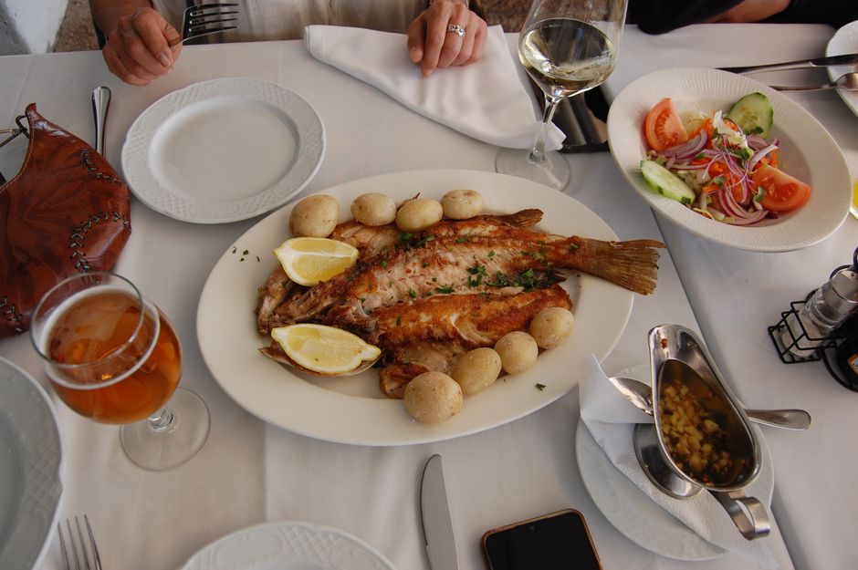 Platter of fresh grilled fish and white wine Croatian tavern