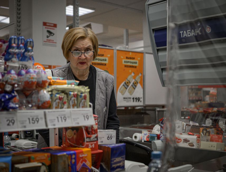 Bulgarian shoppers examining supermarket prices