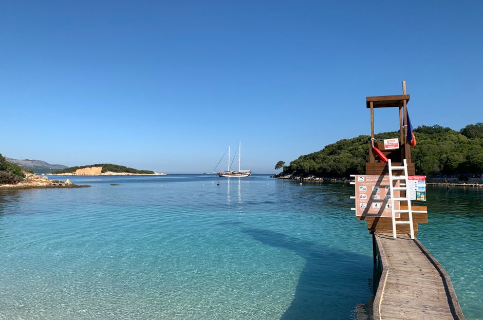 Ksamil Beach Albania pink sand clear water crowded tourists