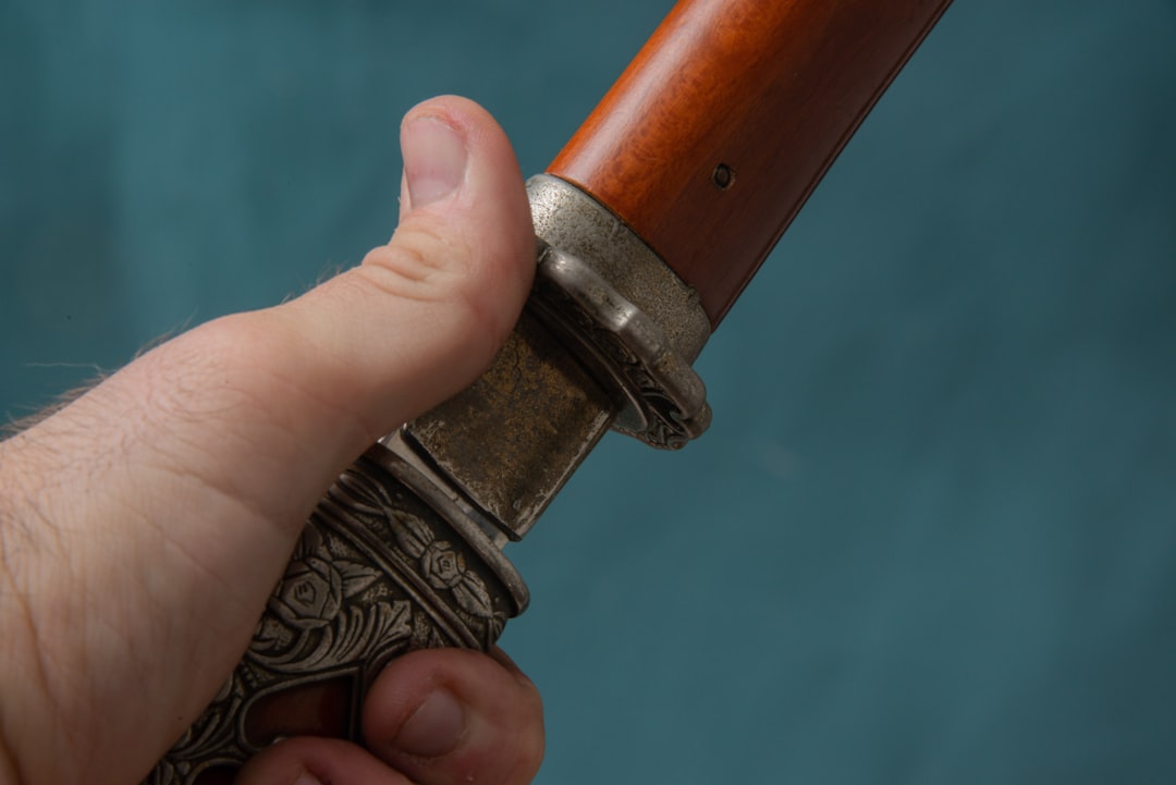 Greek traditional triaena weapon close up wooden handle metal prongs
