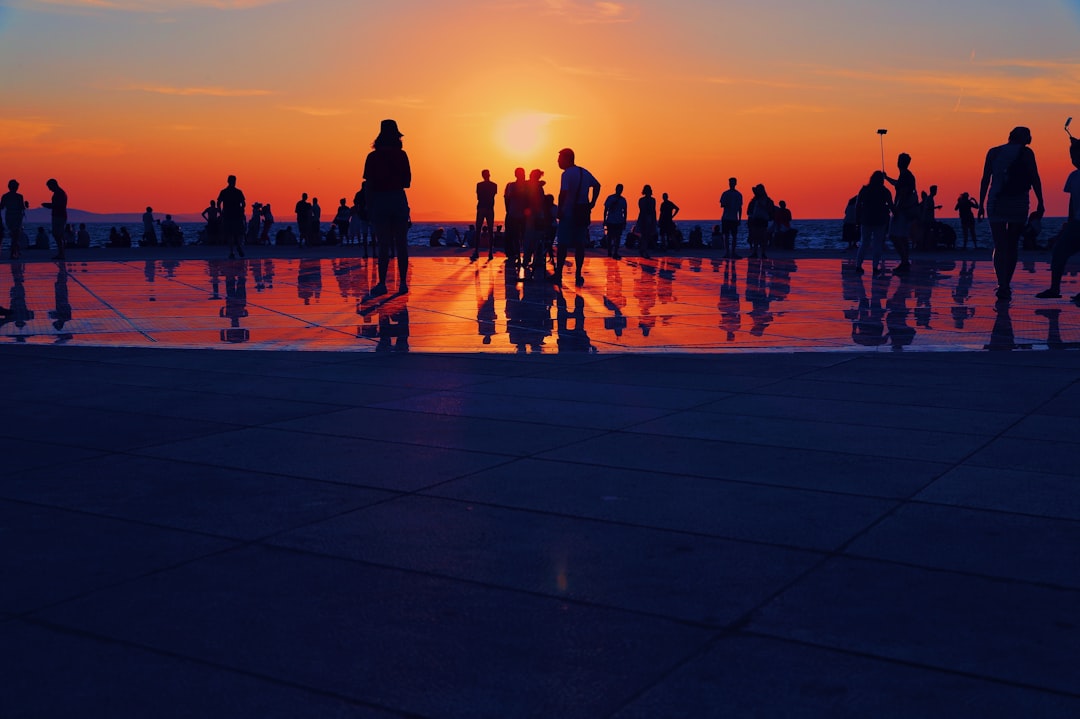 Zadar Obala kneza Višeslava promenade bars evening lights crowd