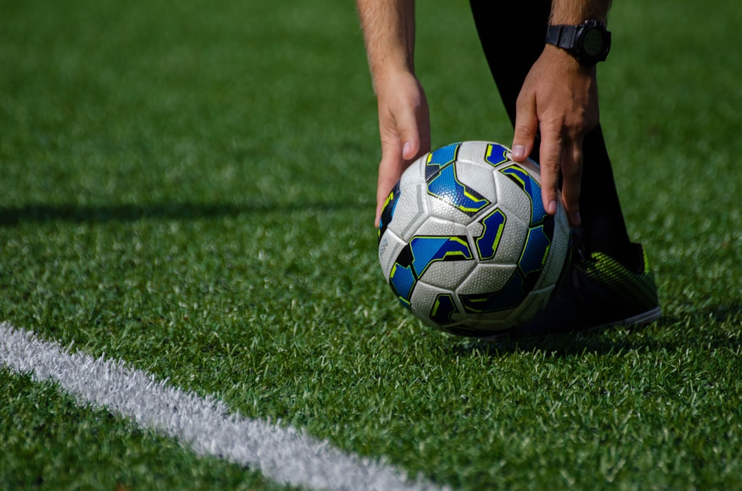 FIFA referee holding match ball before kickoff