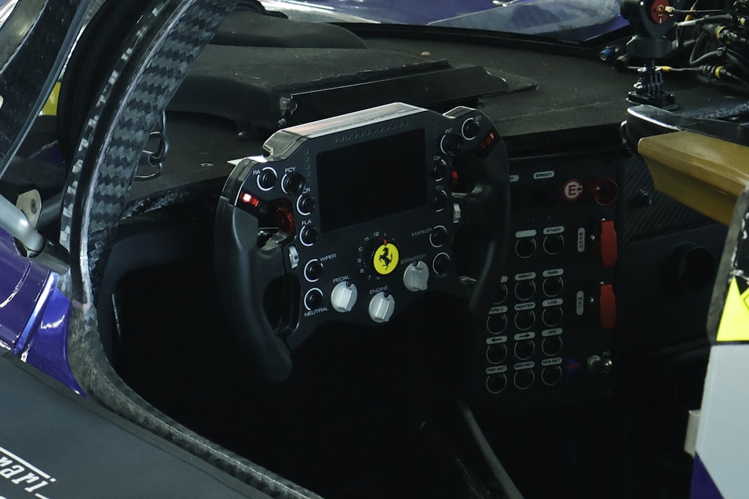 Lewis Hamilton holding Ferrari steering wheel simulator