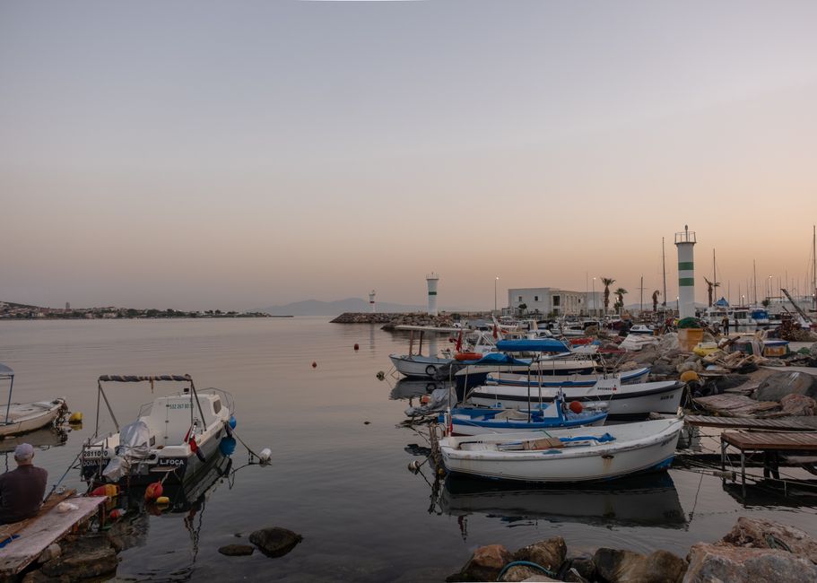 Petra harbor Crete small fishing boats calm water sunset
