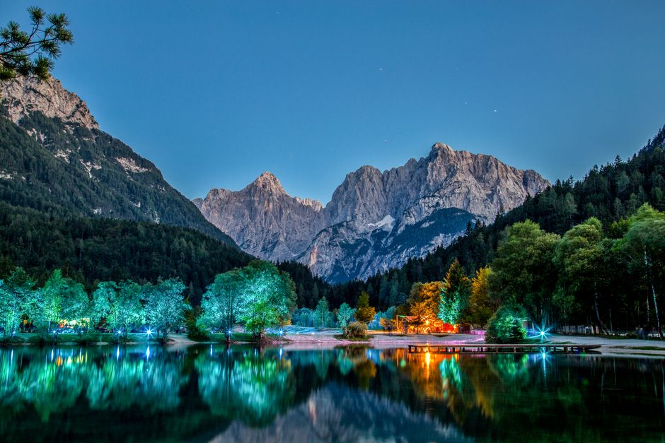 Lake Jasna Slovenia sandy beach blue water Vogel ski resort background summer sunny