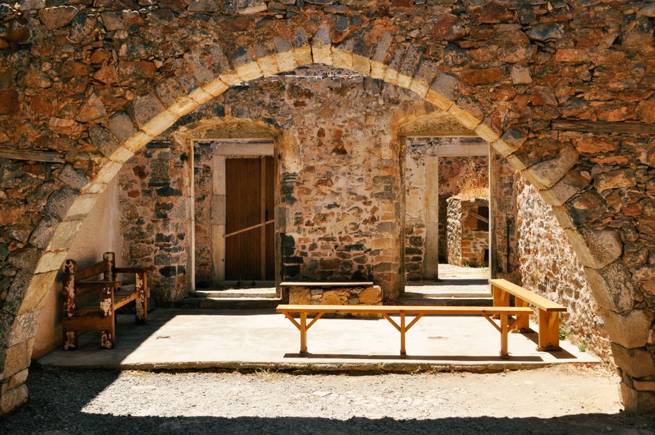 Samaria Gorge entrance gate Omalos Plateau Crete Greece stone archway hikers