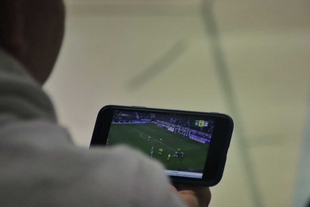 Balkan fan watching football match on smartphone