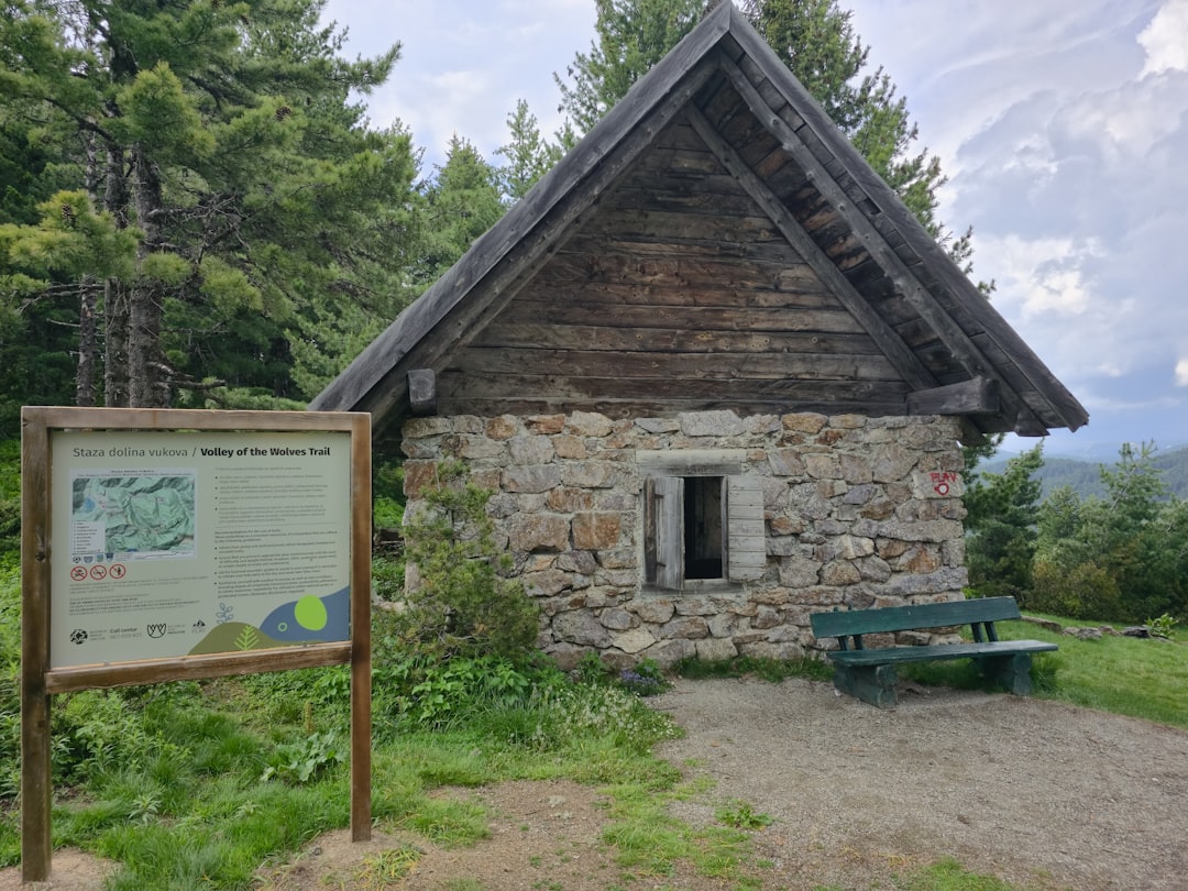 Planinarsko sklonište Sutjeska mountain refuge stone building forest background