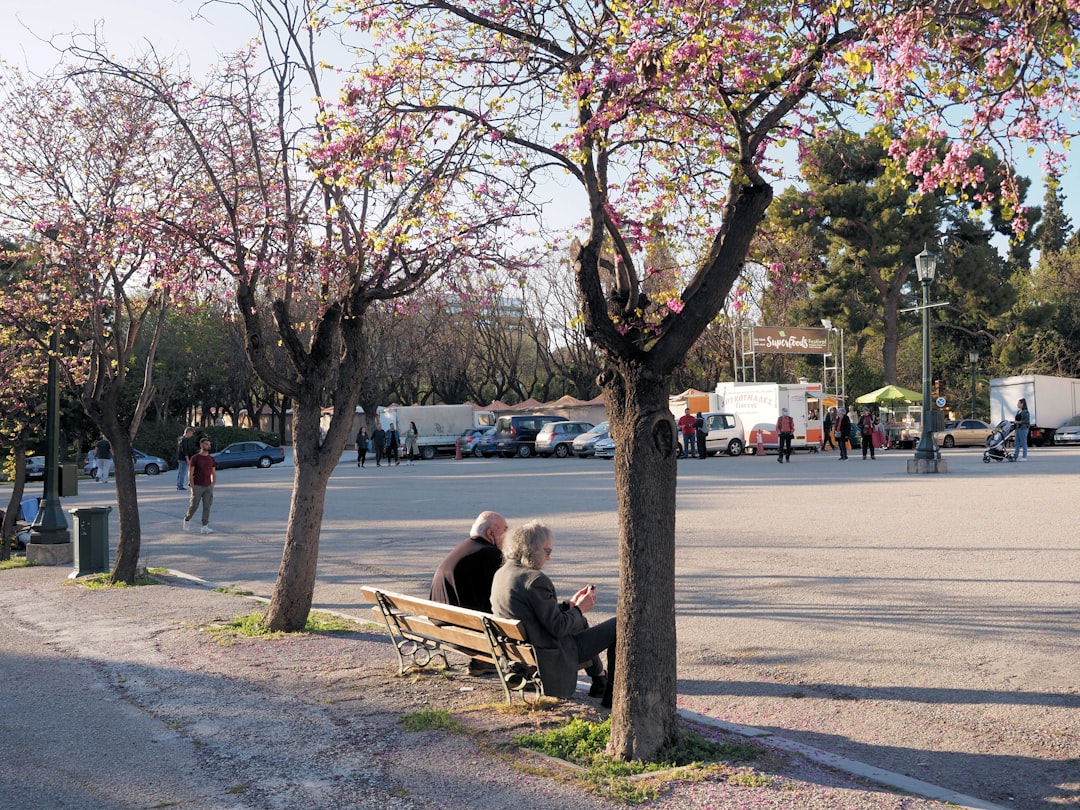 Crowded public park in Athens with people seeking shade