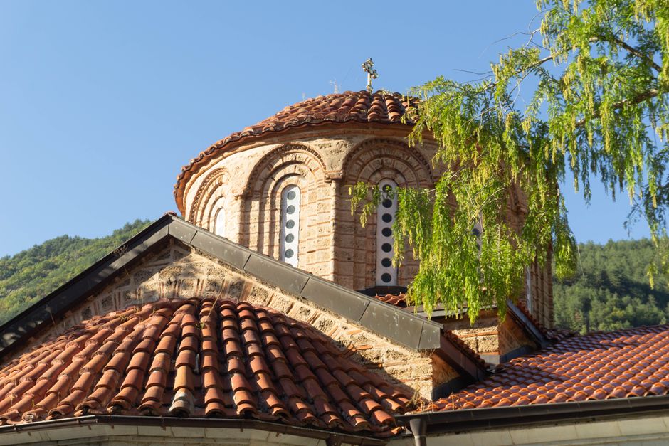 Rila Monastery Bulgaria main church exterior colorful frescoes sunny day