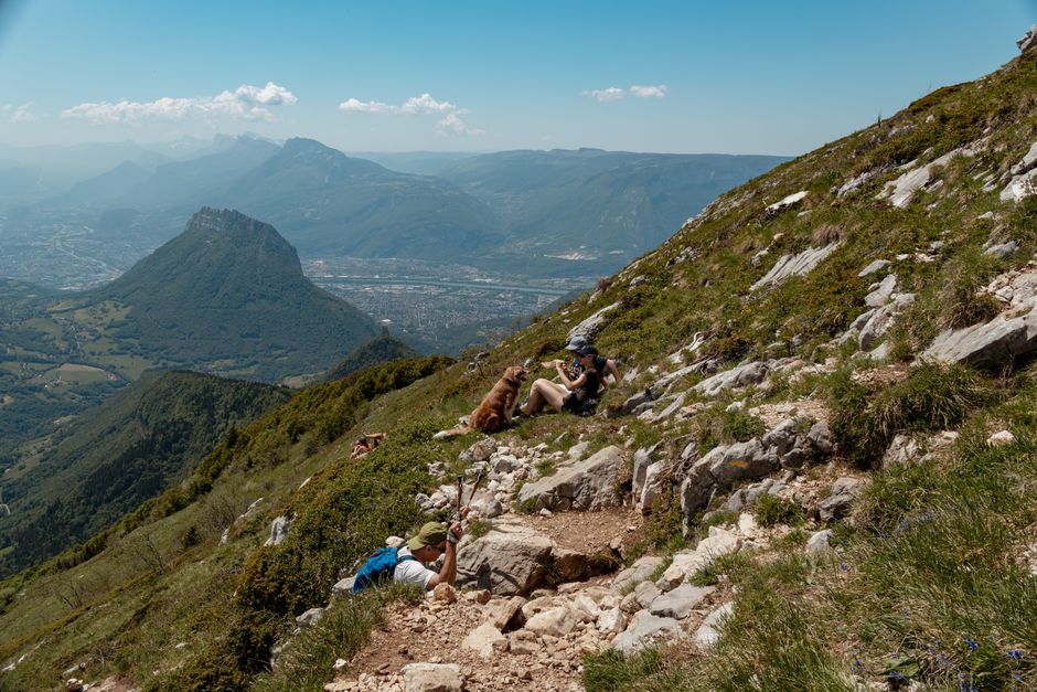 Hiker on steep rocky trail Maglić Mountain Bosnia backpack panoramic view