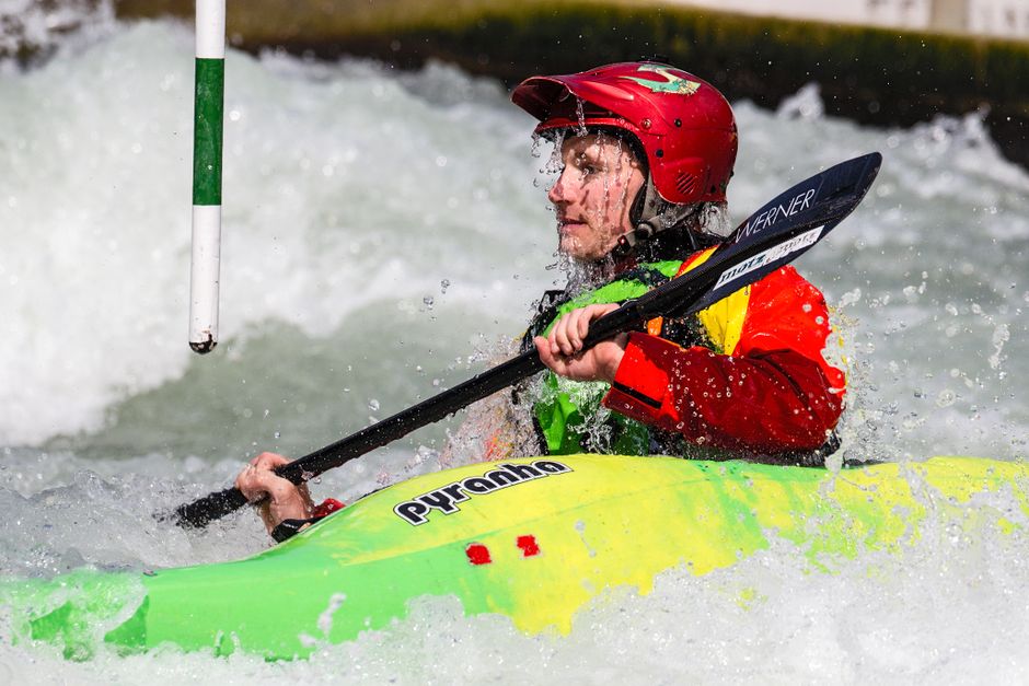 Kayaker in drysuit navigating Class III rapids on Una River Bosnia