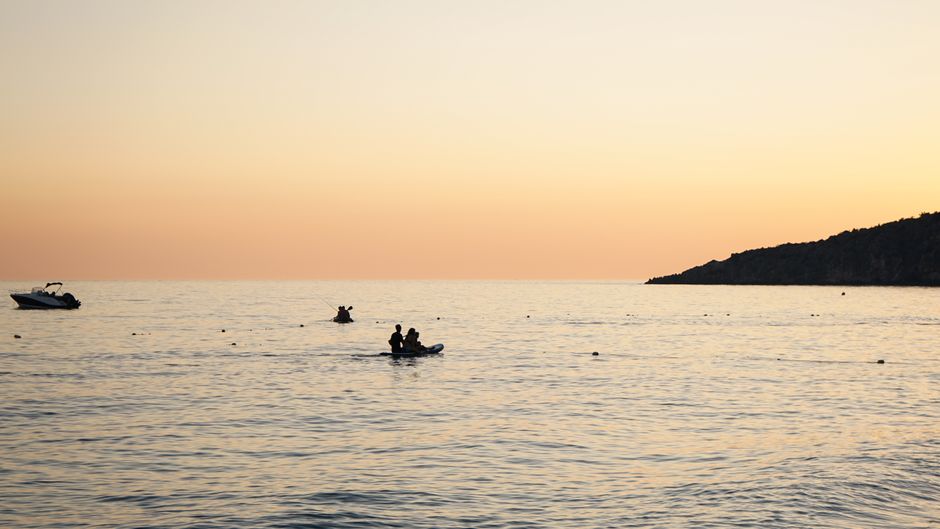 Karaburun National Park Albania coastal cliffs kayaker sunrise