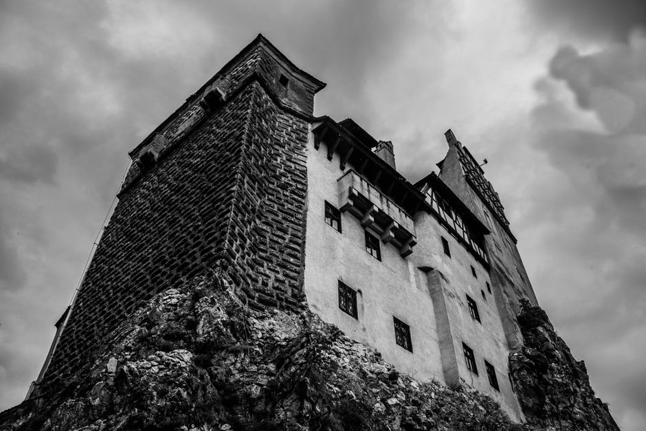 Bran Castle Romania exterior rocky outcrop morning light