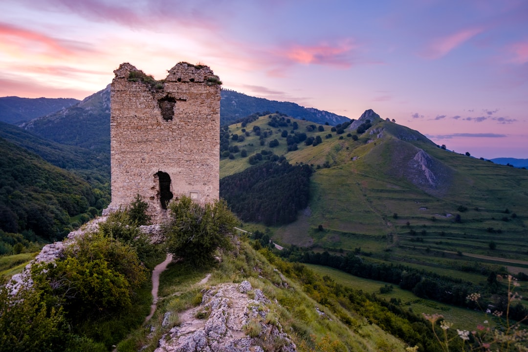 Rasnov Fortress Romania stone walls Fagaras Mountains view sunset