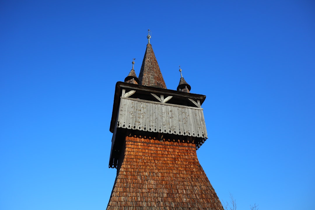 Săpânța Wooden Church Romania tall bell tower spruce shingles rain