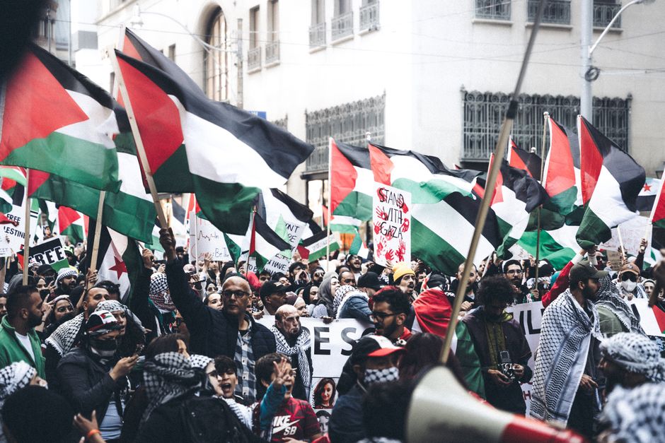 Protesters in Belgrade holding Palestinian flags