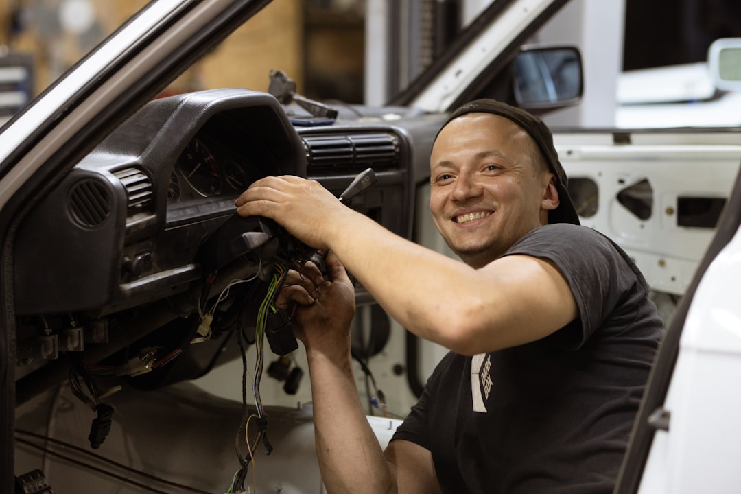 mechanic inspecting car air conditioning evaporator core