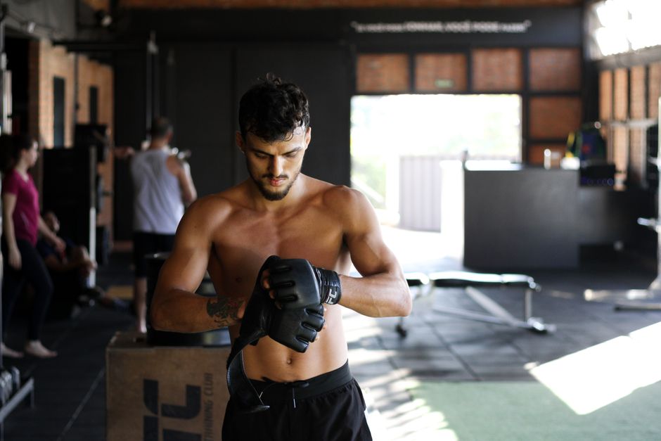 UFC fighter posing with championship belt gym