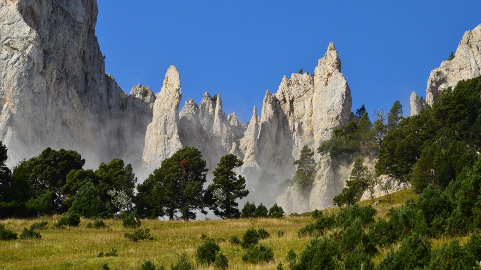 Velebit Mountains Croatia cave entrance limestone cliff pine trees