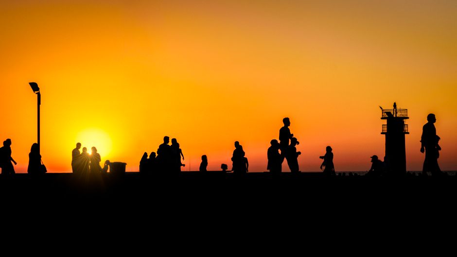 Portorož sandy beach sunset people walking promenade