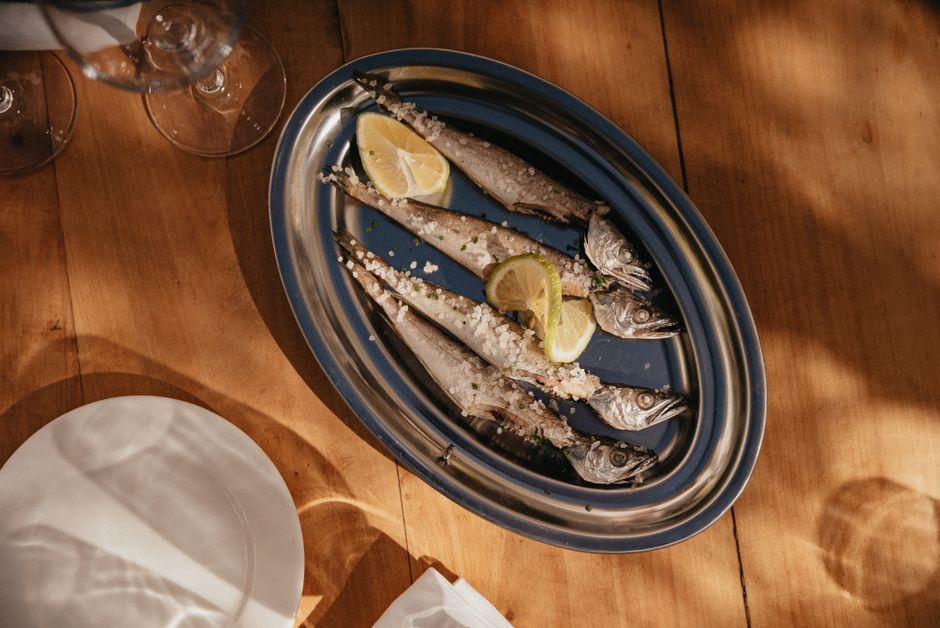 Chalkidiki Greece traditional taverna table grilled fish bourdeto stew white wine