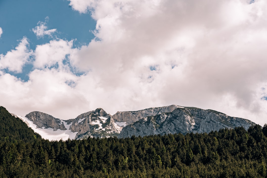 Maglic peak Bosnia Herzegovina rugged limestone karst cliffs clouds