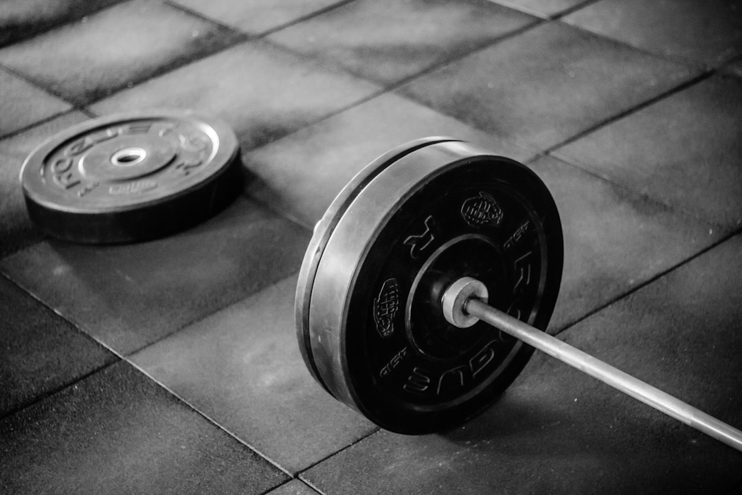 CSKA Sofia weightlifting gym vintage black and white athletes lifting heavy barbell chalk dust atmosphere
