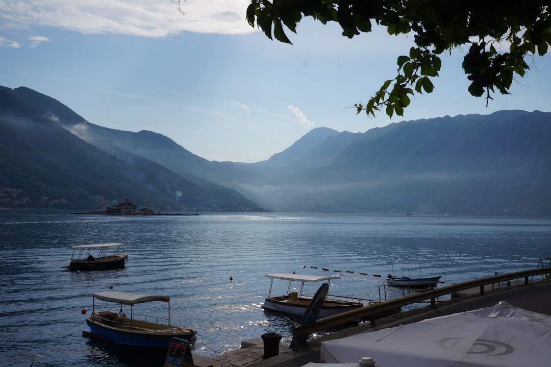 Old Port Kotor fishing boats tourists morning calm water