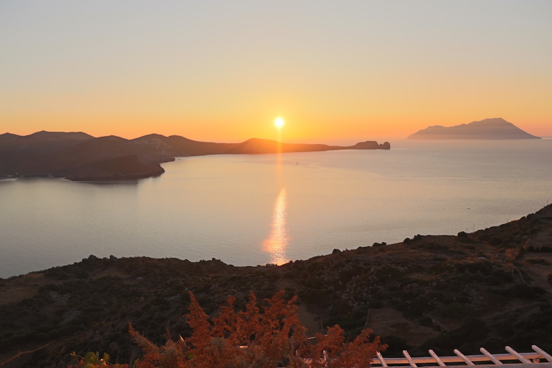 Milos Island Greece sunset view from Pollonia village harbor boats