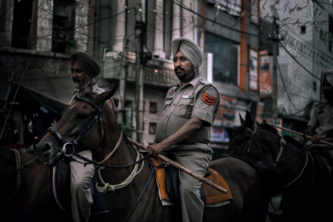 Indian police officers seizing mobile phones during investigation