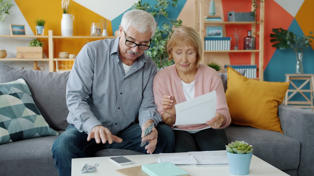Elderly couple reviewing pension documents at home