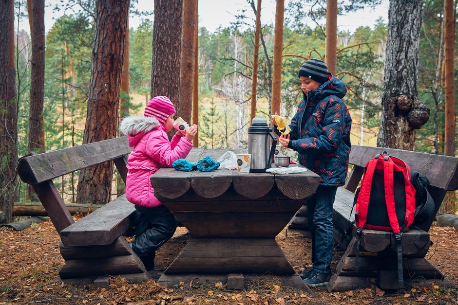 Velebit Wall Hut interior wooden tables hikers eating stew