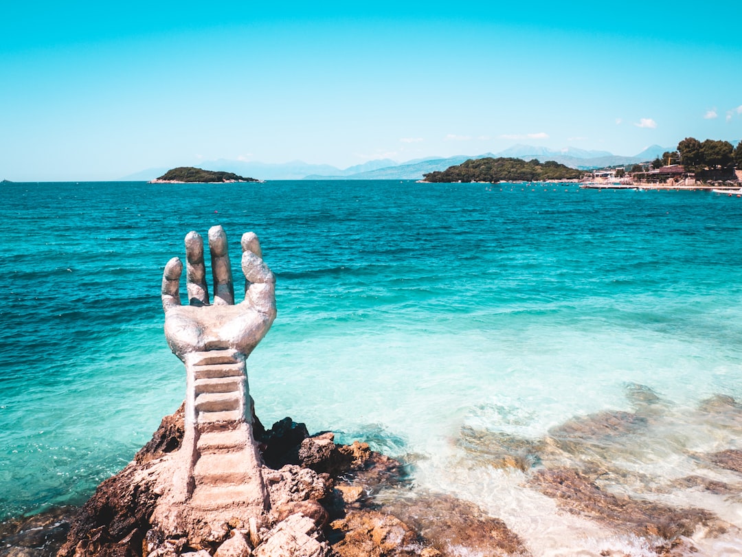 Ksamil Albania shingle beach grey pebbles turquoise water rocky coast