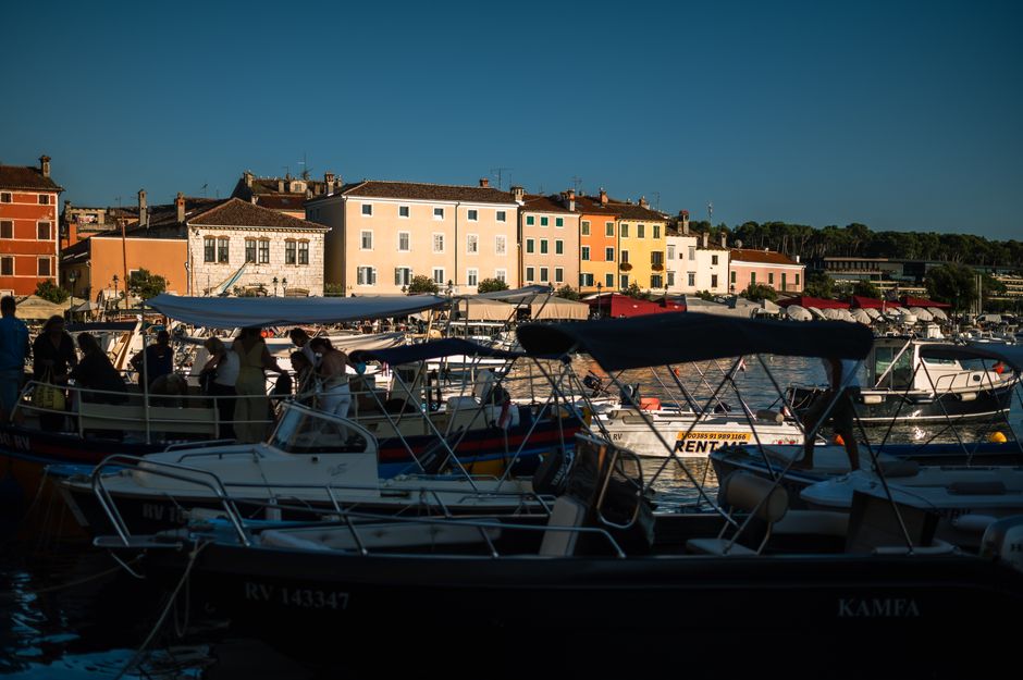 Komiža harbor Croatia stone houses fishing boats sunset