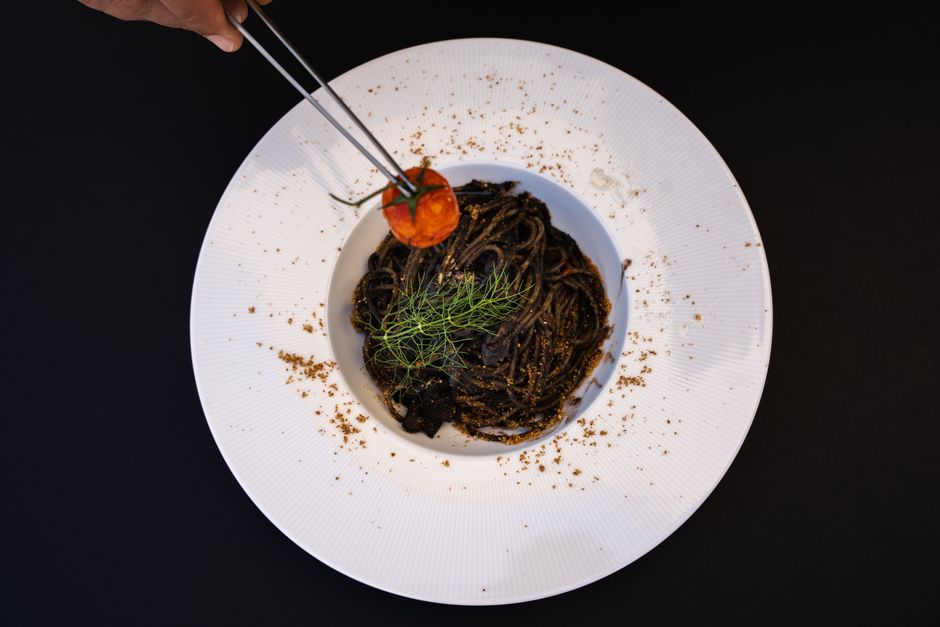 Crni Rižot black risotto squid ink Kotor Bay Montenegro restaurant plate