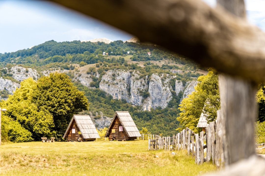 Zabljak town square Montenegro wooden houses mountains background