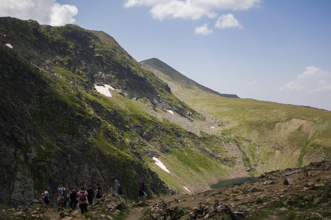 Hiker on trail Seven Rila Lakes Bulgaria rocky path mountain view