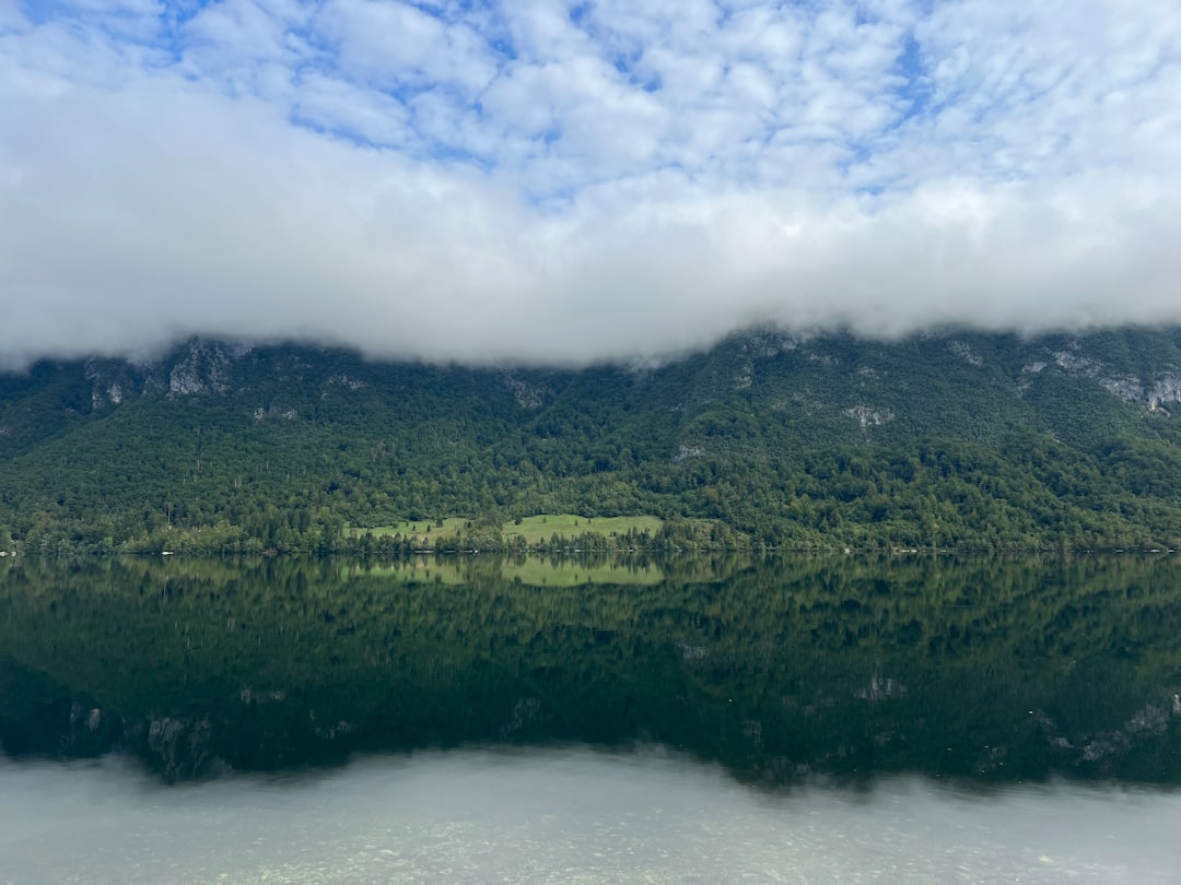 Bohinj Lake Slovenia rowboat mountain reflection
