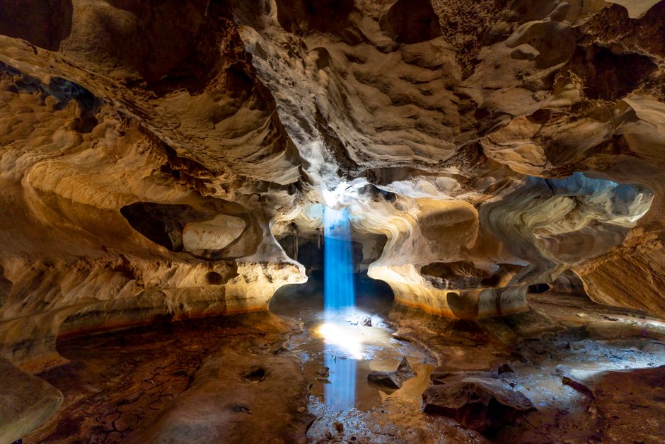Kamenjak Cave Croatia interior stalactites flashlight beam