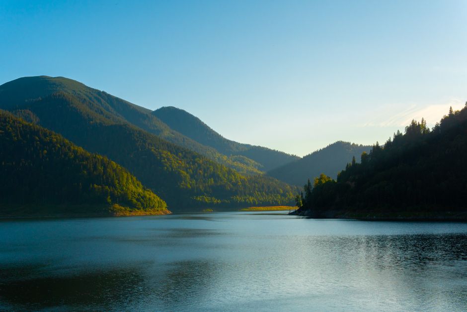 Retezat National Park glacial lake reflection mountains clear blue water